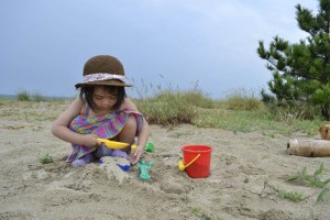 child playing at the beach