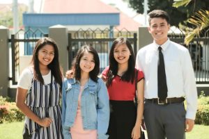 a group of youth in front of a chapel