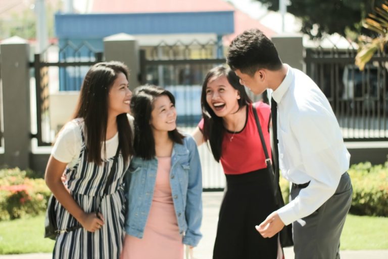 youth gathered around a less-active friend