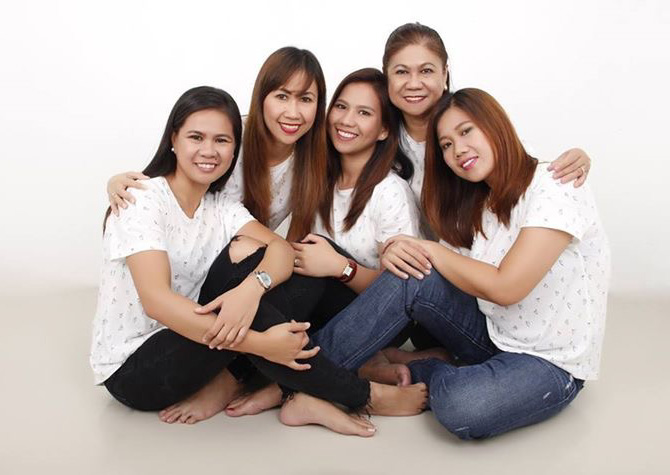 mother with daughters sitting down on floor