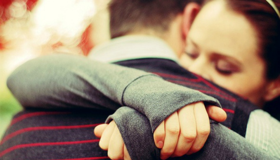 man and woman hugging