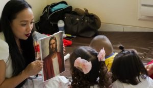 A mom teaching her kids about Jesus.