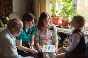 Sister missionaries teaching a boy