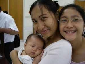 baby in mother's arms with aunt
