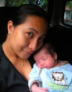baby carried by mother