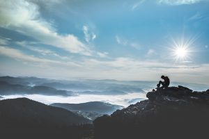 man on top of mountain
