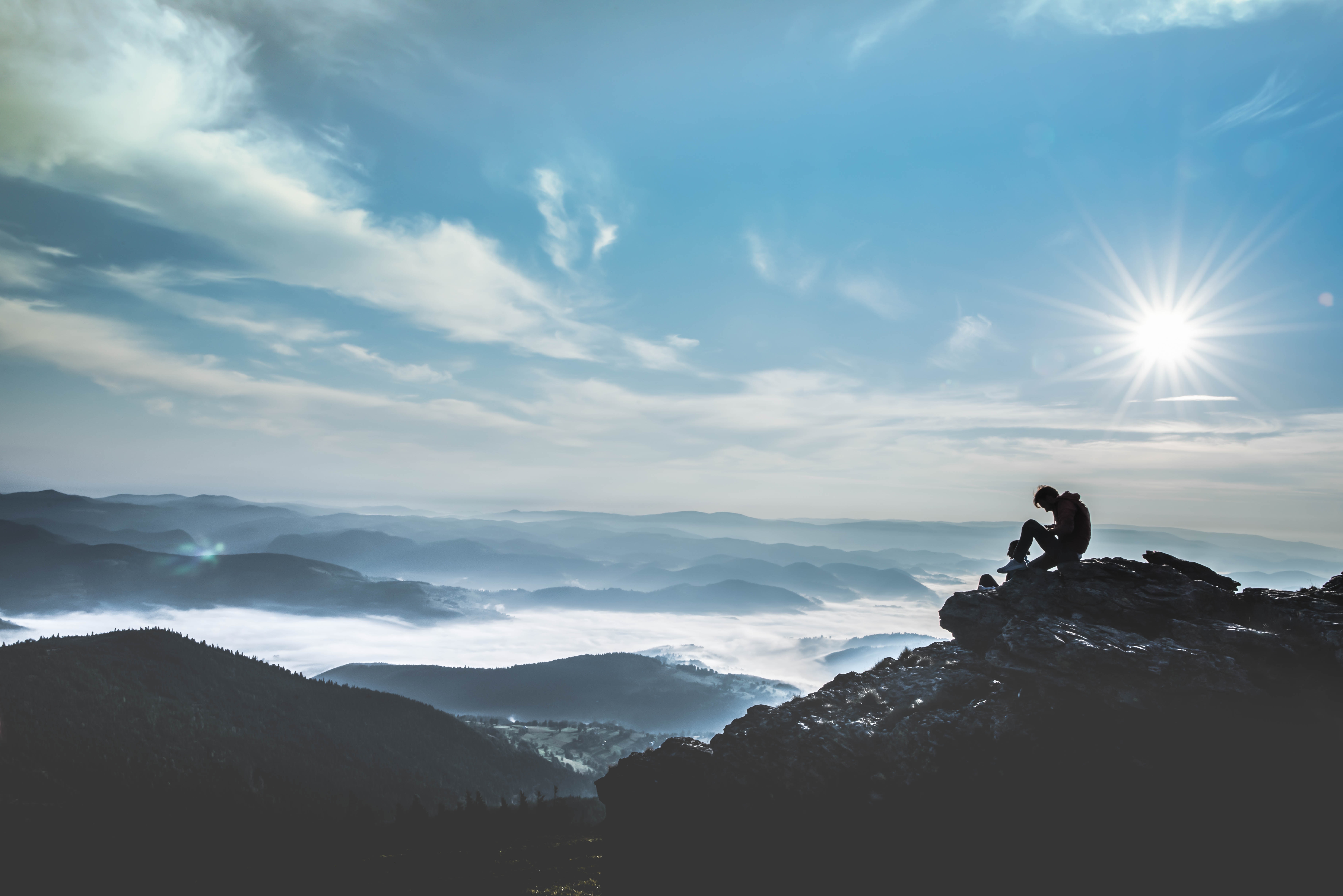 man on top of mountain