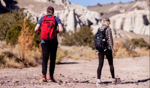 man and woman hiking in dessert