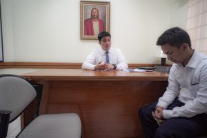 man talking to a religious leader