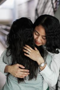 woman hugging a person