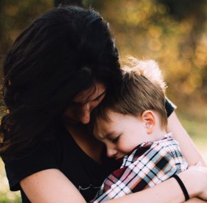 mother holding her son in her arms