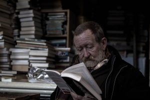 man in library reading